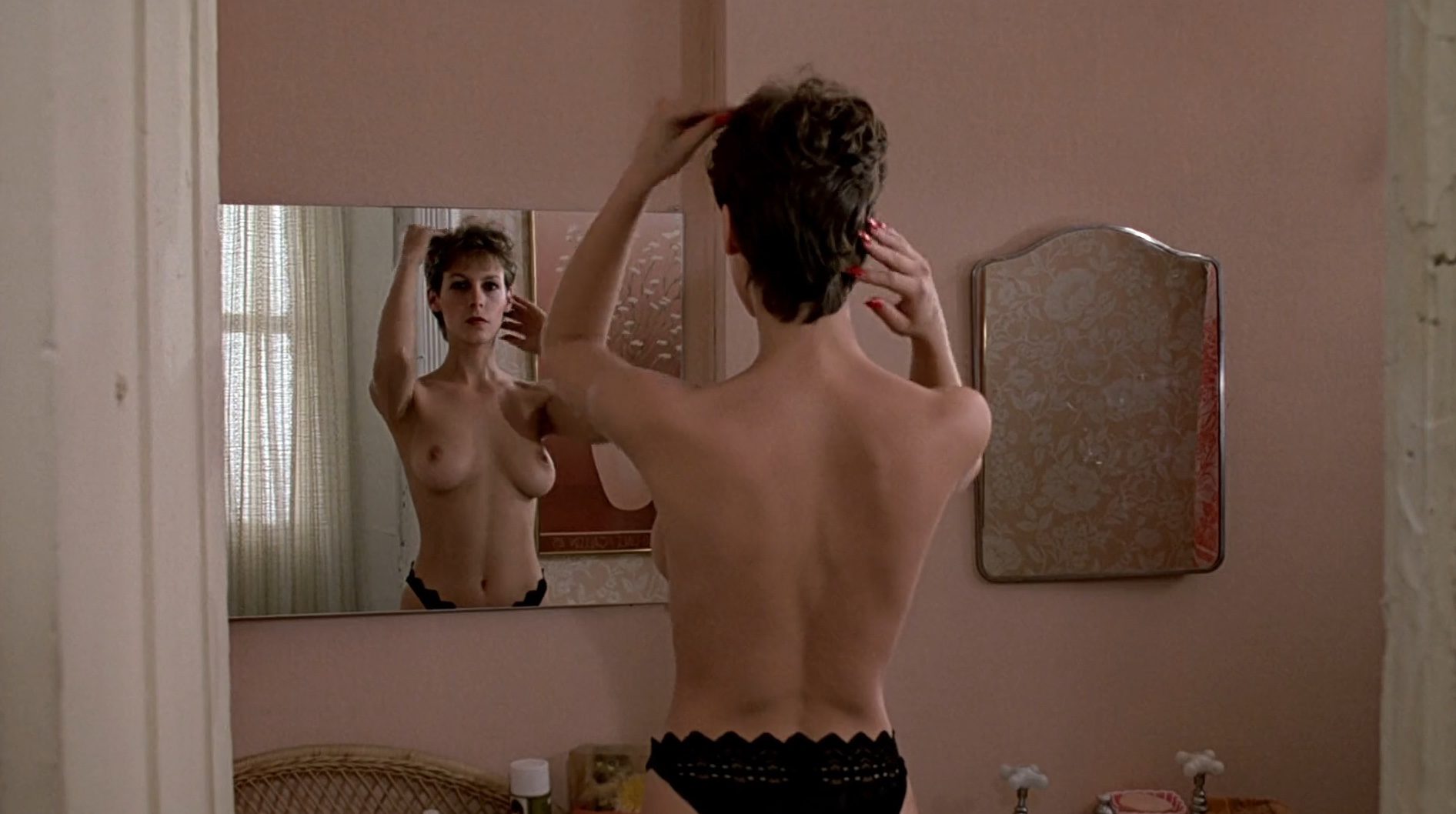 Jamie Lee Curtis desnuda frente al espejo en 'Entre pillos anda el juego'