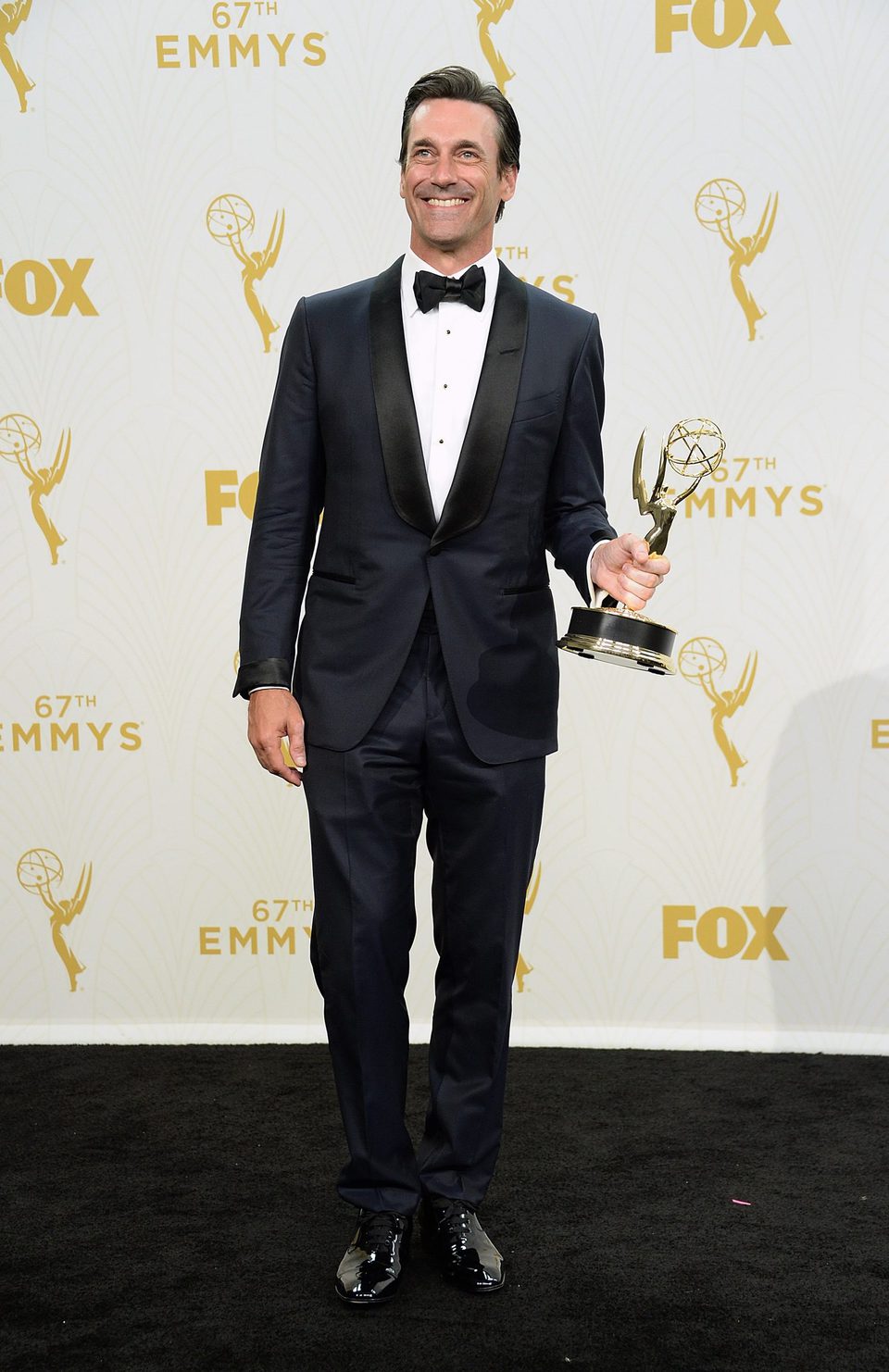 Jon Hamm posando con su Premio Emmy 2015